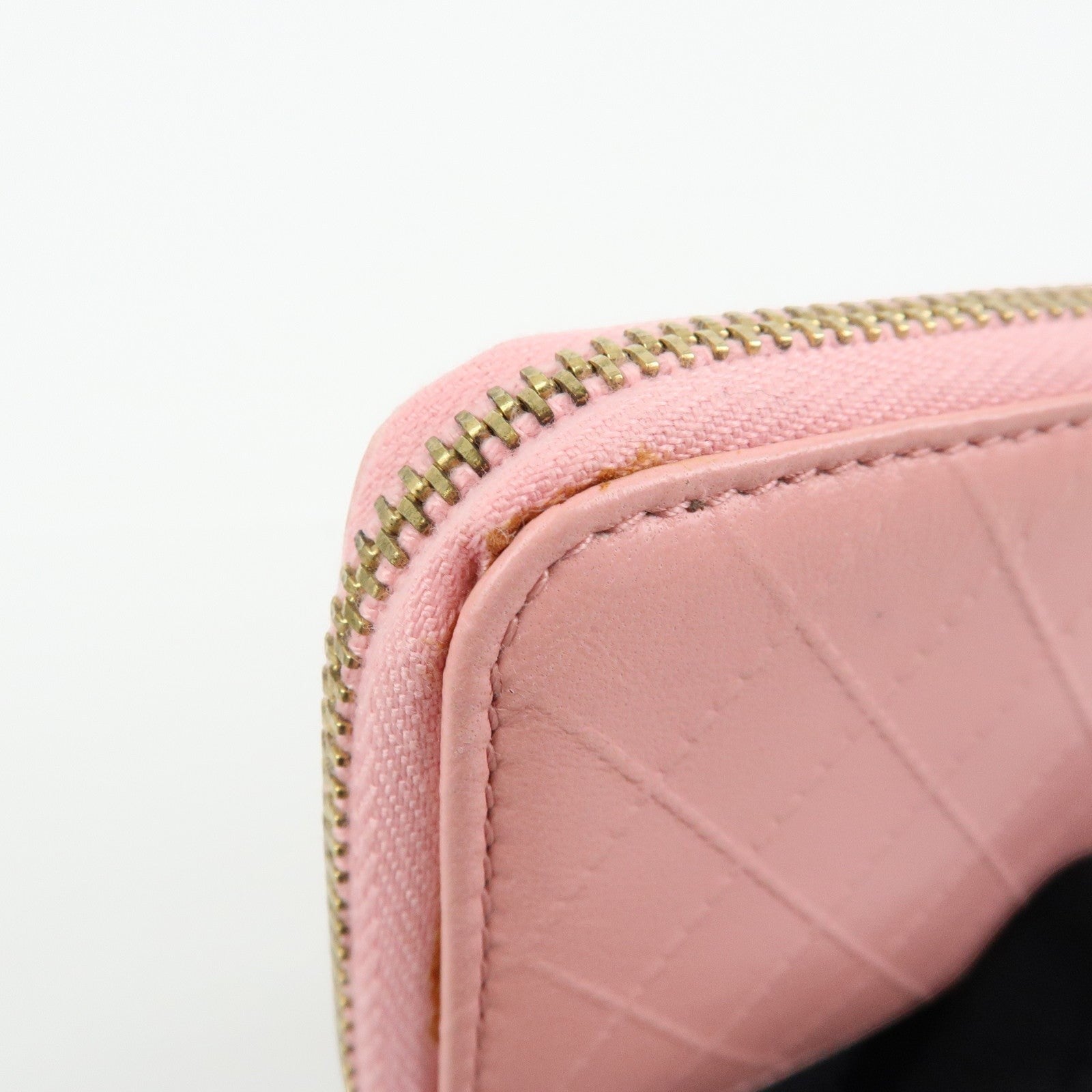 CURATED by Kira pink quilted leather zip-around card holder with gold-tone hardware and floral charm.