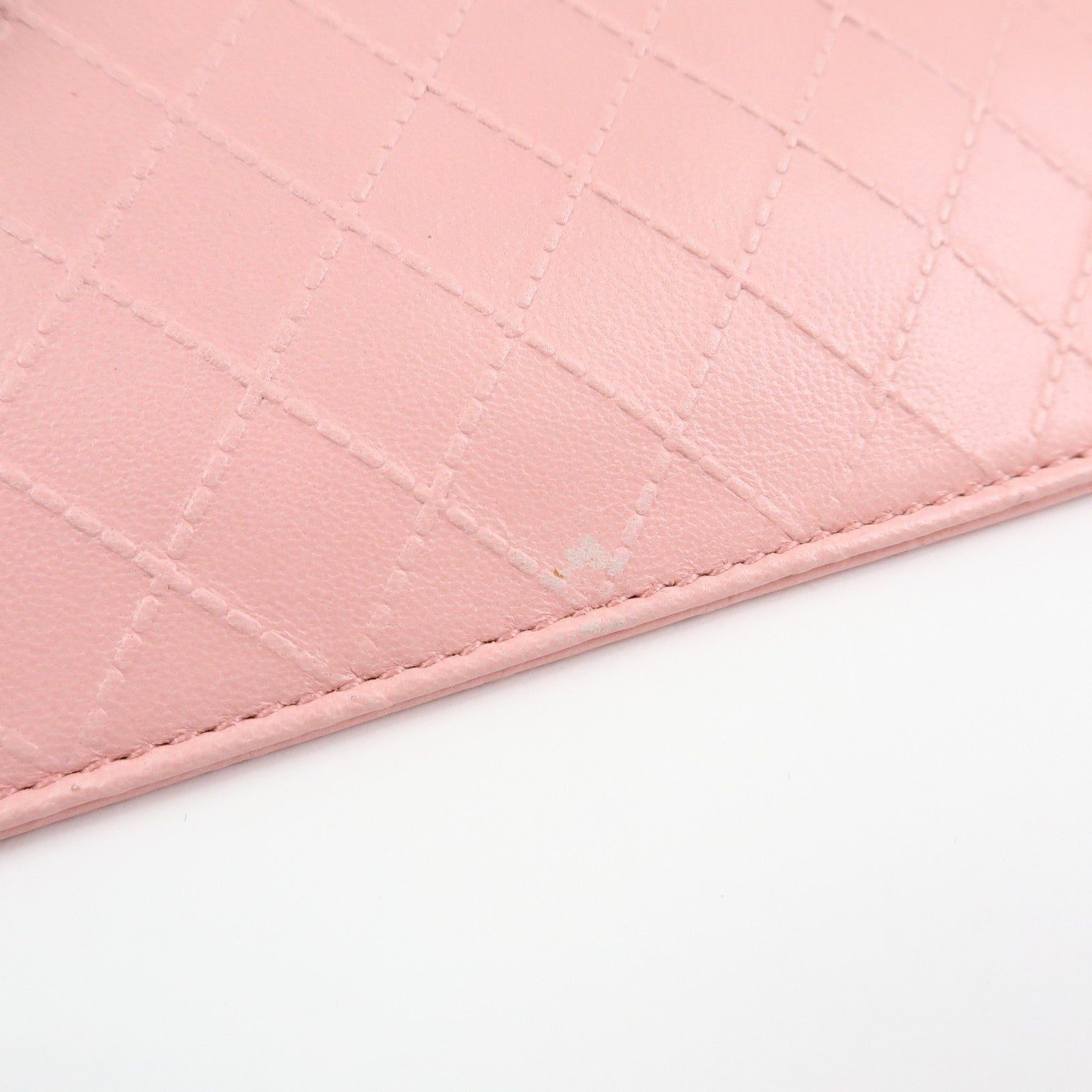 CURATED by Kira pink quilted leather zip-around card holder with floral charm detail.