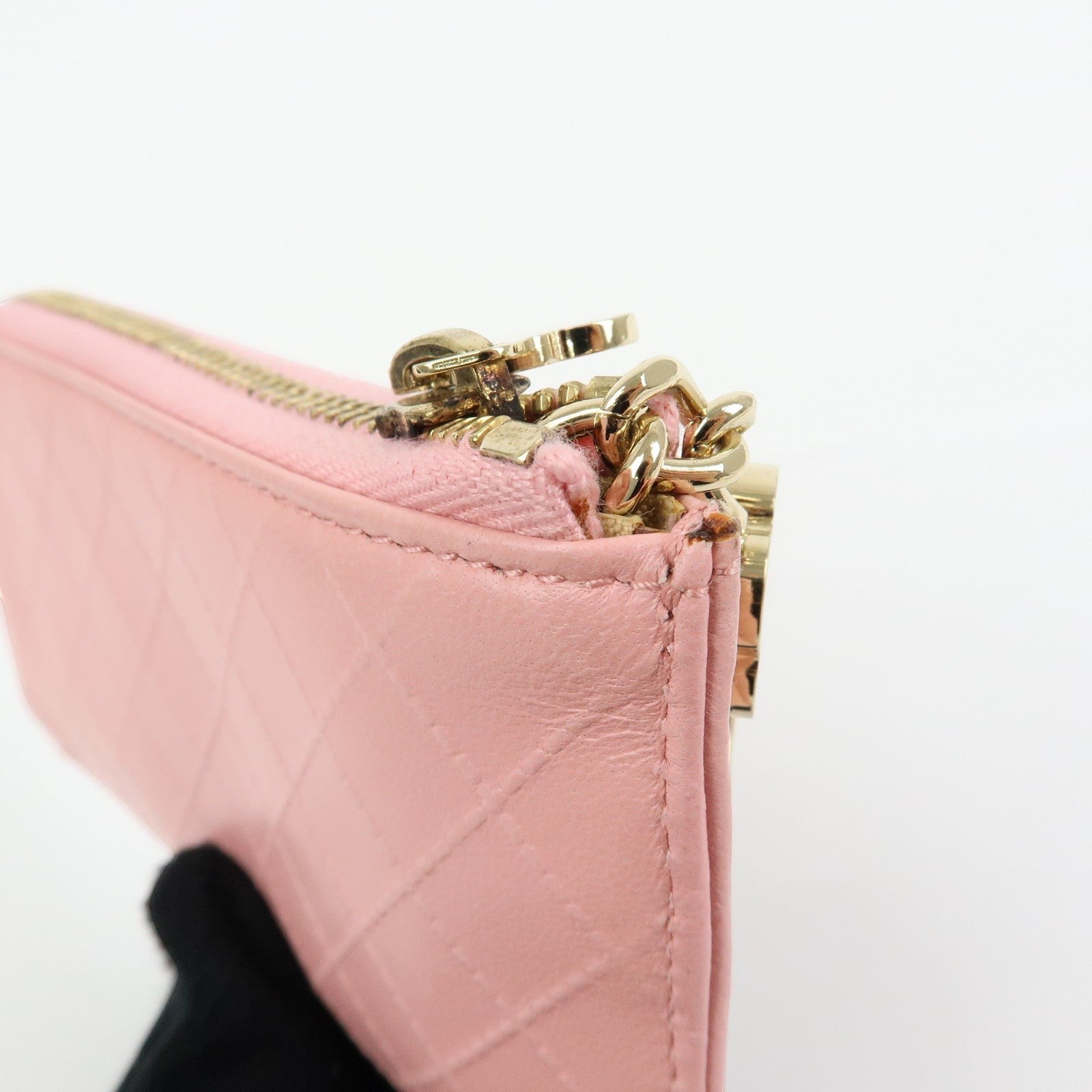 CURATED by Kira pink quilted leather zip-around card holder with gold chain detail and floral charm.