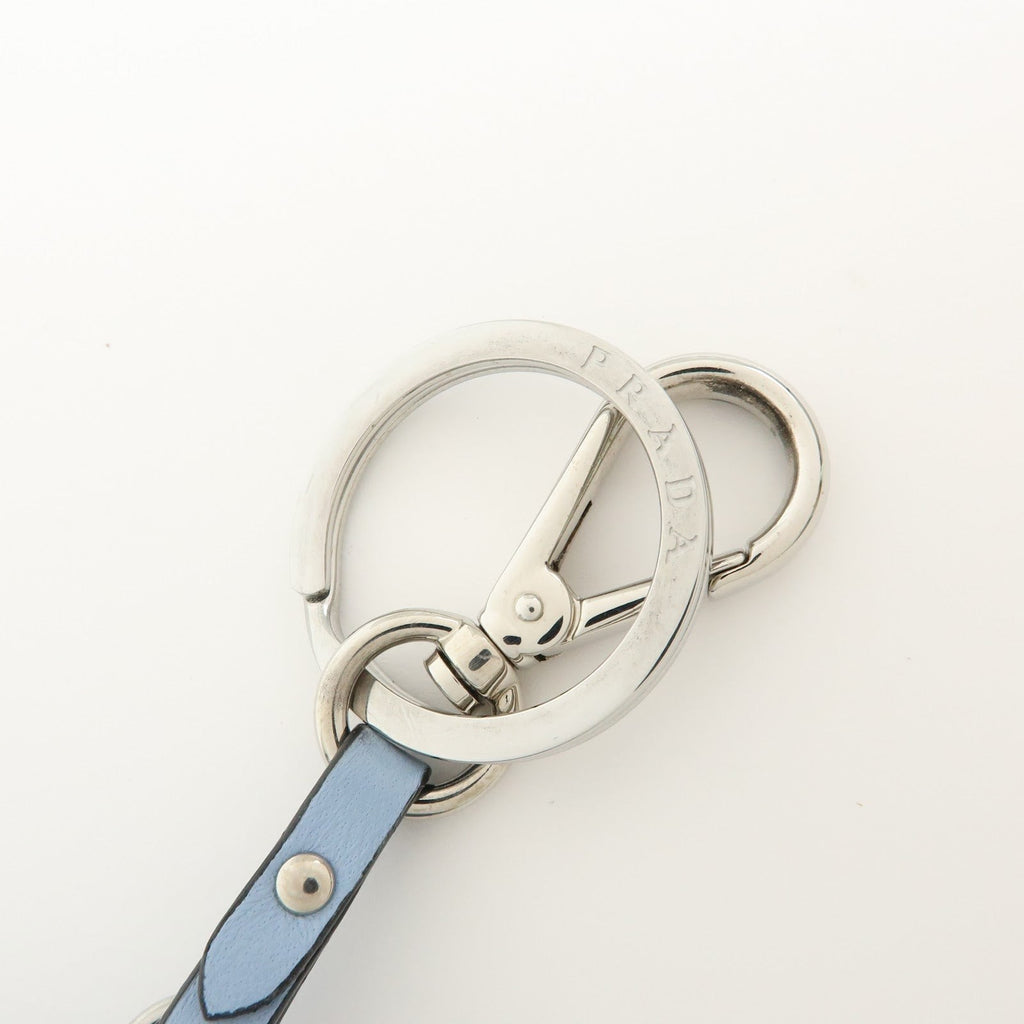 CURATED by Kira light blue Saffiano leather dolphin charm keychain with silver-tone hardware and Prada triangle logo.