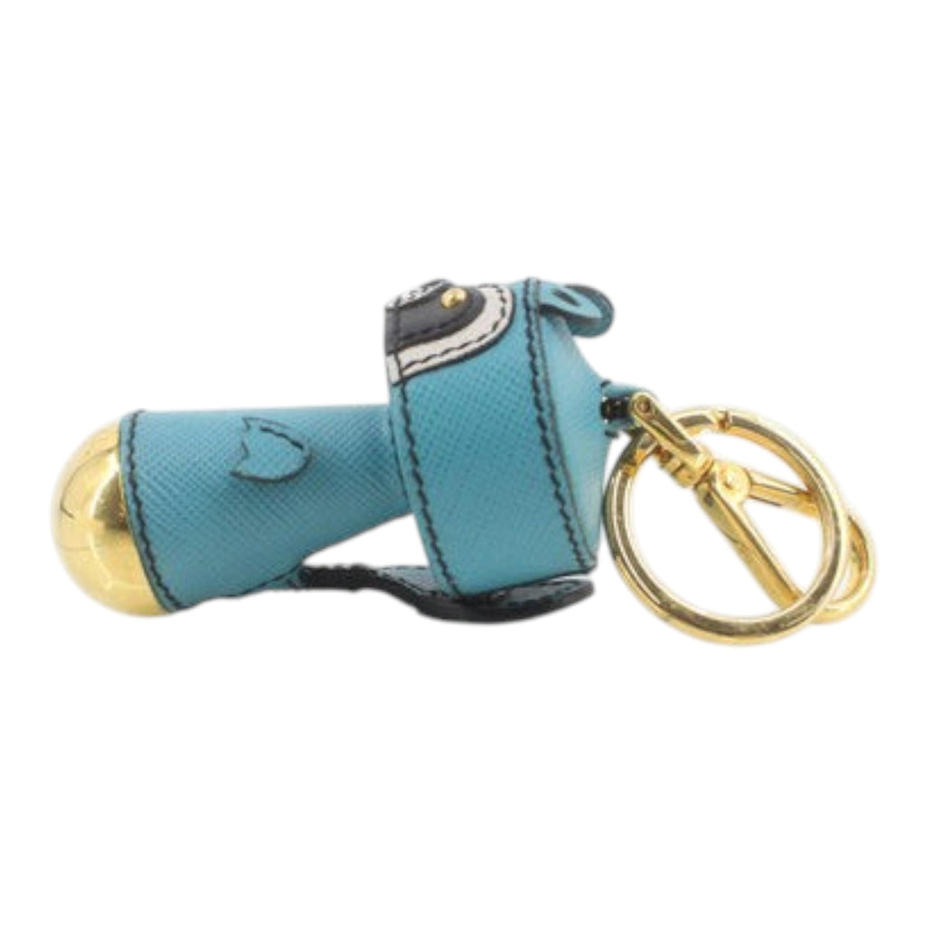 CURATED by Kira Prada raccoon key ring in teal Saffiano leather with gold-tone hardware and a circular key loop.