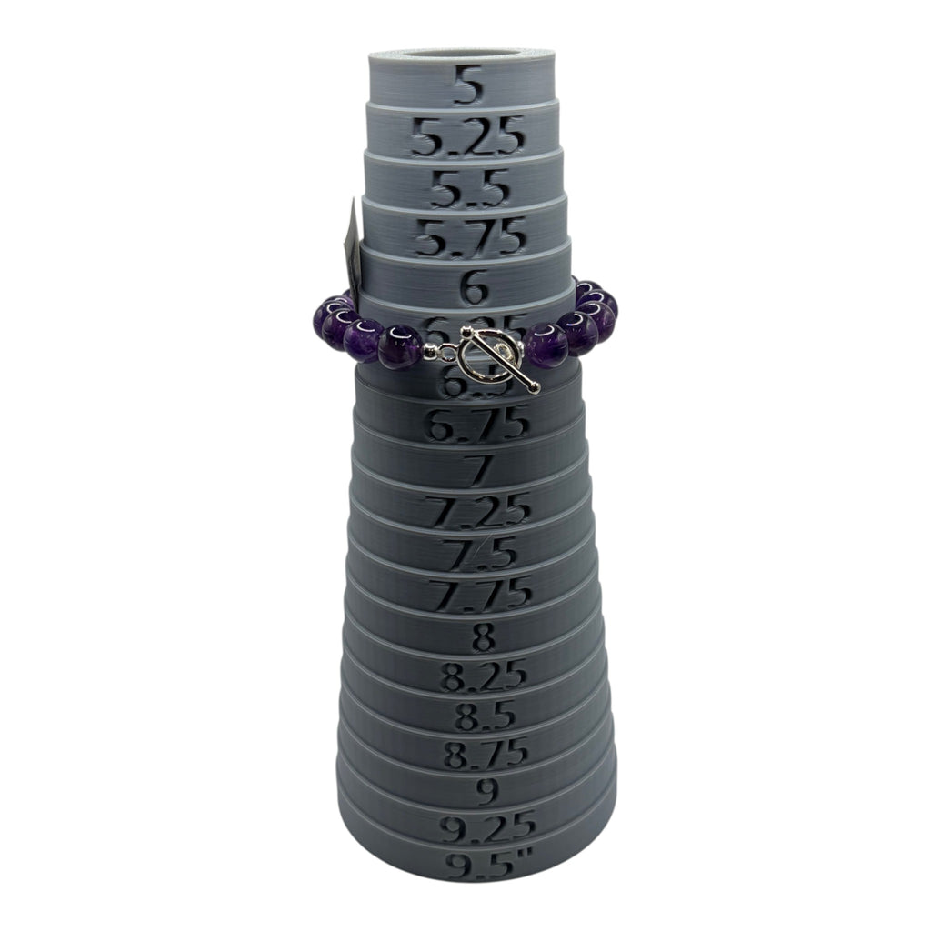 CURATED by Kira purple faceted bead bracelet with a silver toggle clasp displayed on a grey ring sizing mandrel