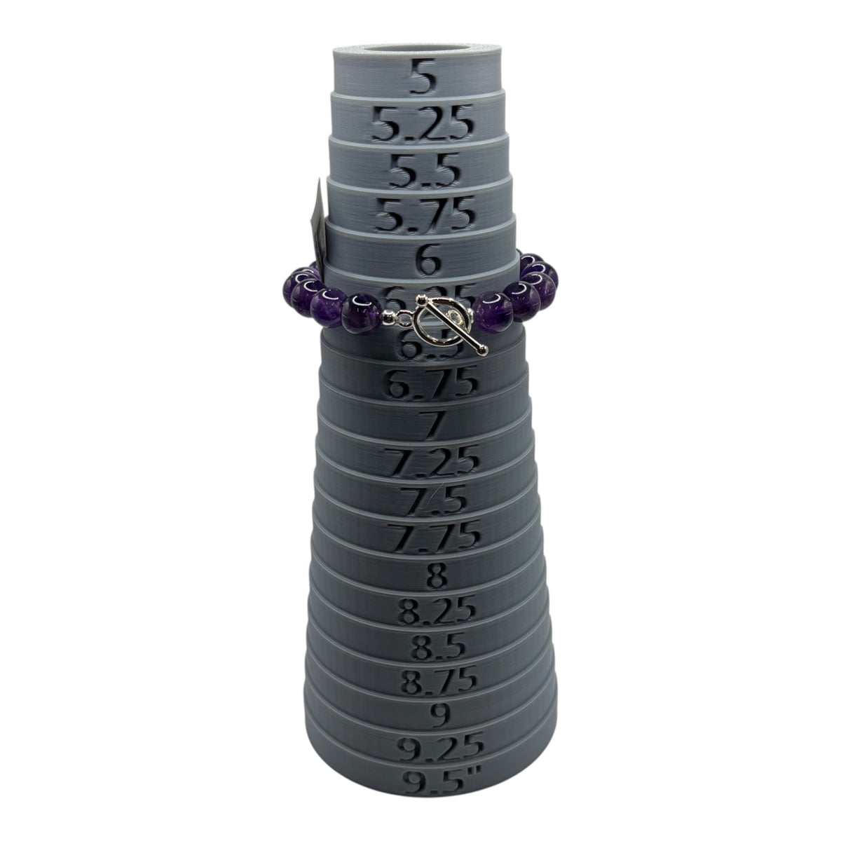 CURATED by Kira purple faceted bead bracelet with a silver toggle clasp displayed on a grey ring sizing mandrel
