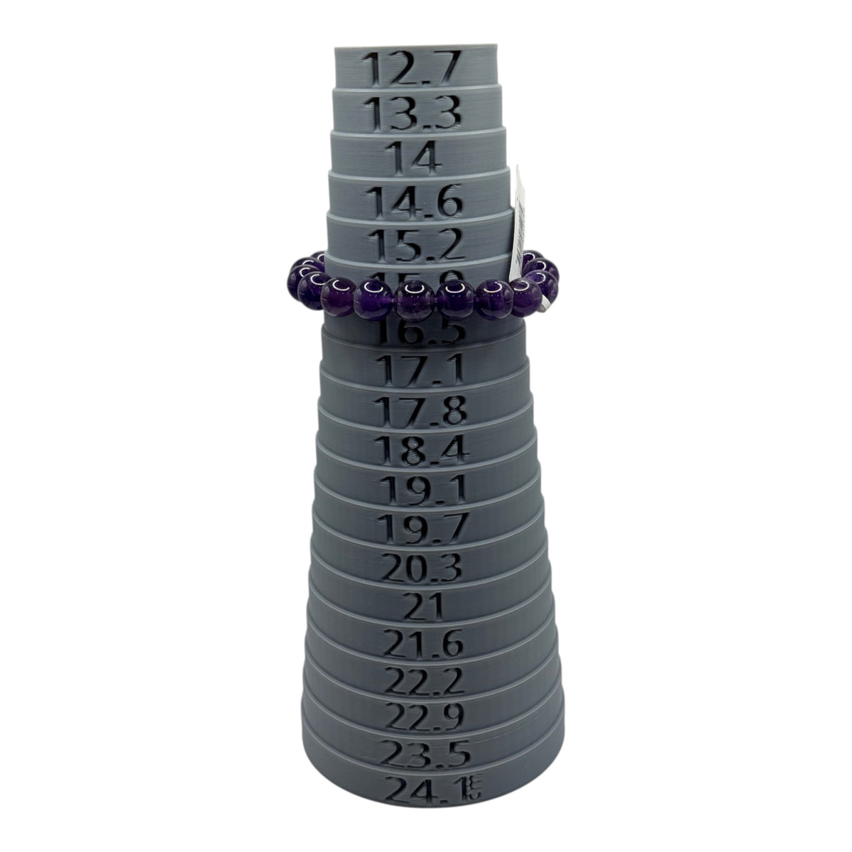 CURATED by Kira purple faceted bead bracelet with a silver toggle clasp shown on a grey ring sizing mandrel
