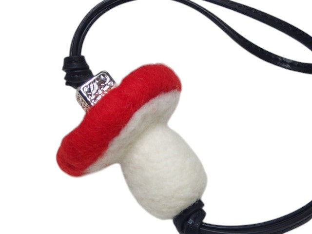 CURATED by Kira red and white mushroom bag charm keychain with silver bead detail and black cord.