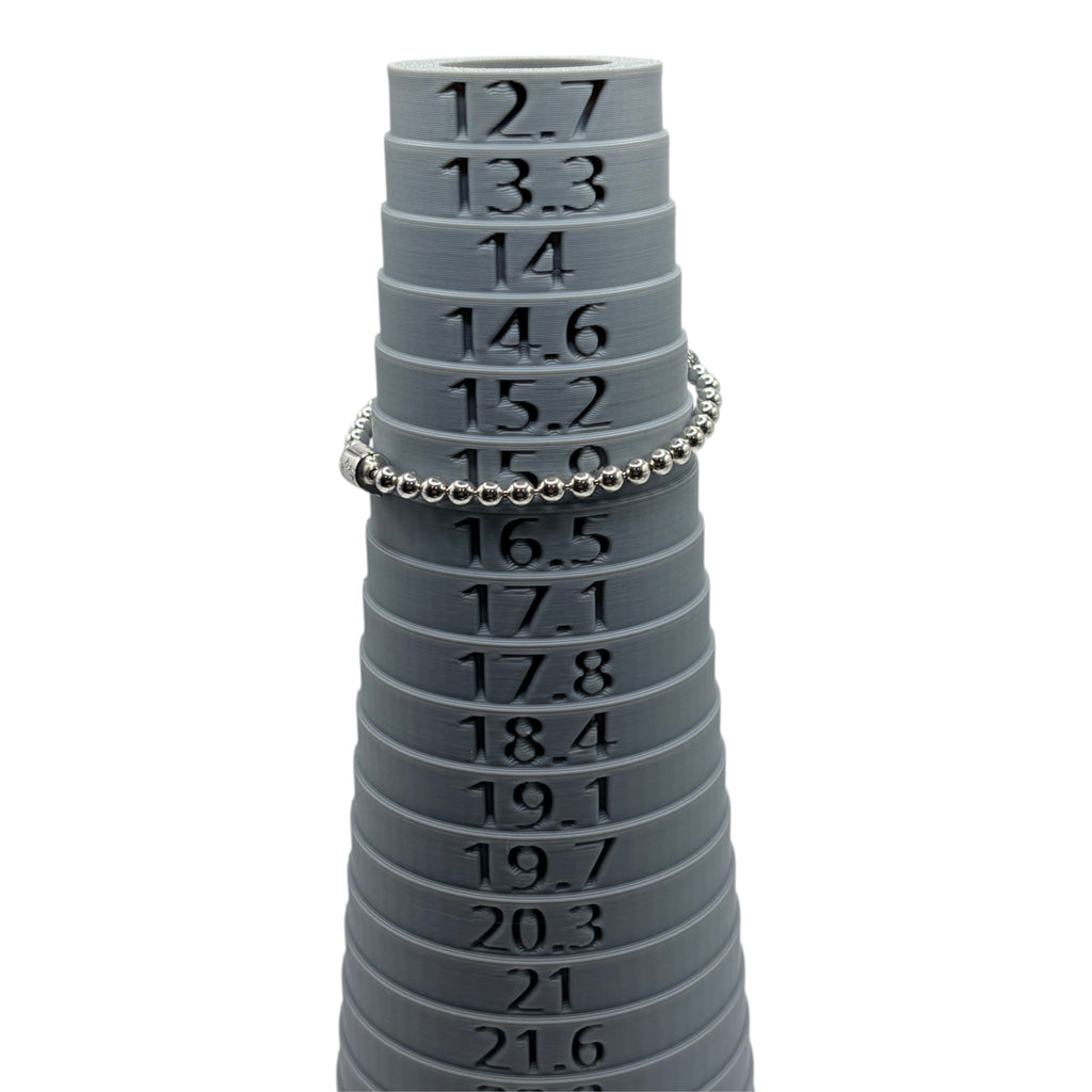 CURATED by Kira Pandora silver tone beaded bracelet with pave crystal ball accent displayed on a grey sizing cone