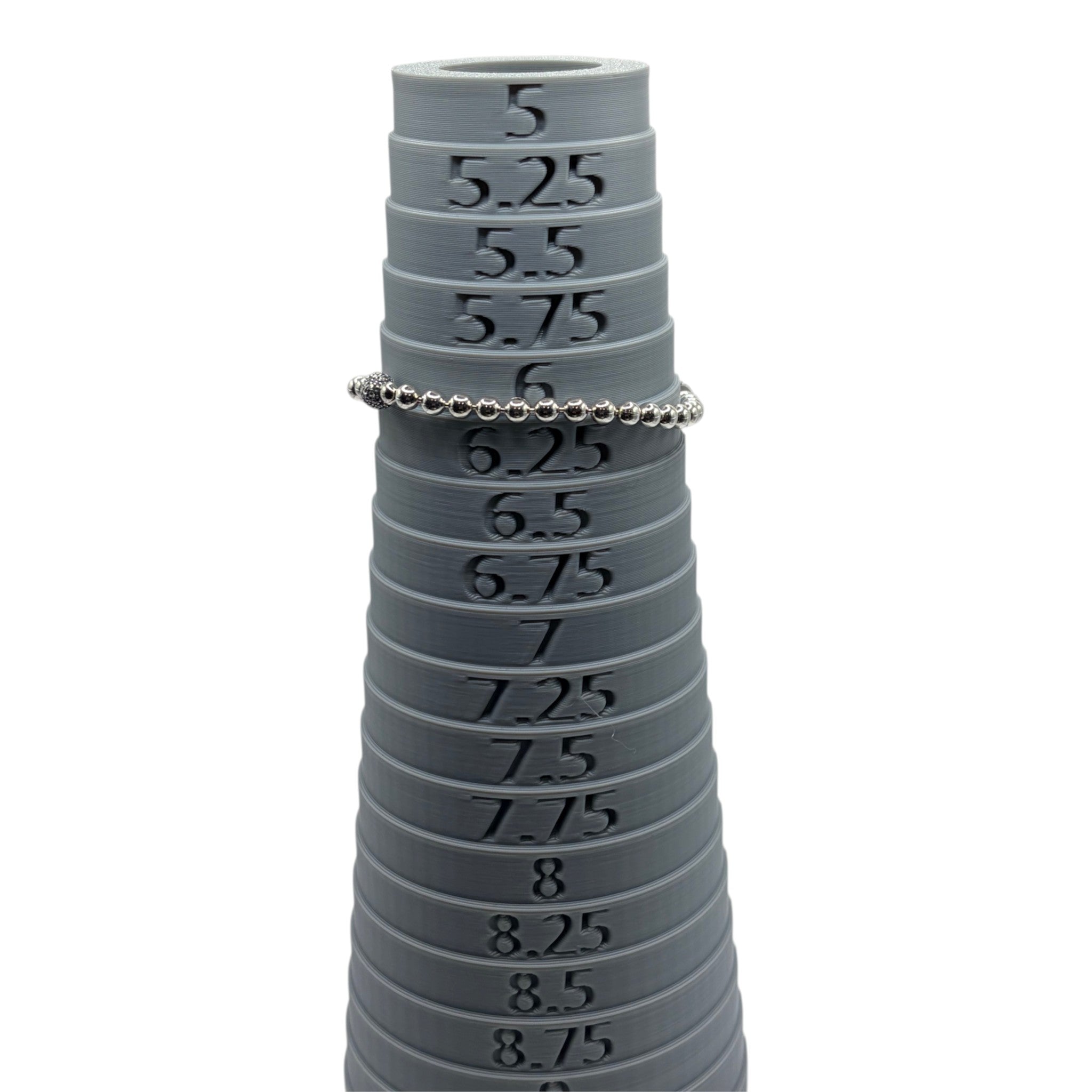 CURATED by Kira silver tone beaded bracelet with pave crystal ball accent resting on a grey ring sizing mandrel