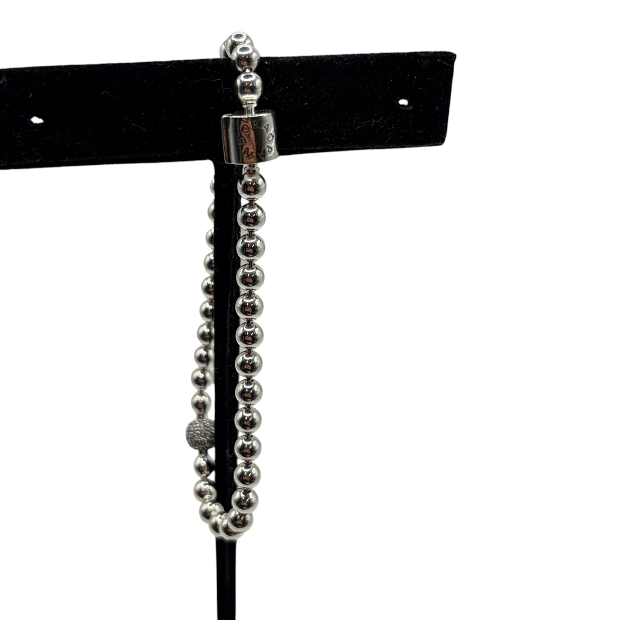 CURATED by Kira silver tone beaded Pandora bracelet featuring a pave crystal ball accent on a black display stand