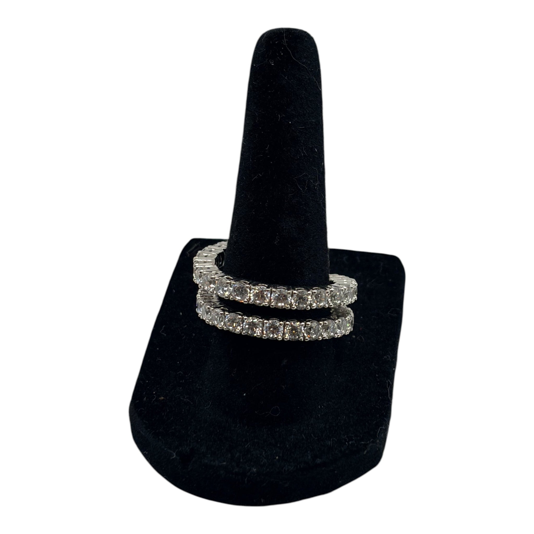 CURATED by Kira silver tone double row eternity band ring featuring sparkling cubic zirconia stones on a black stand