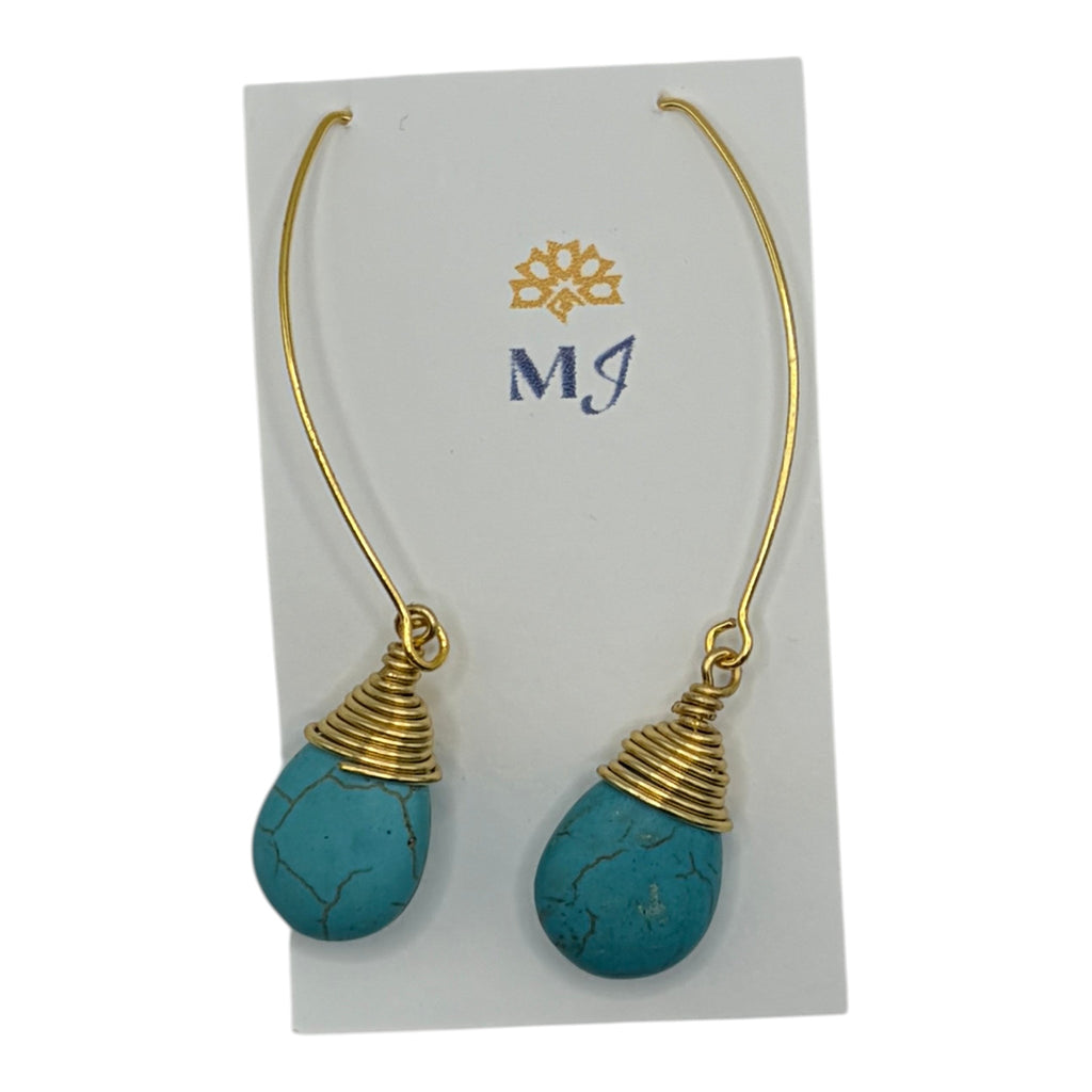 CURATED by Kira MINU Jewels turquoise teardrop dangle earrings with gold tone wire wrap detail on display card