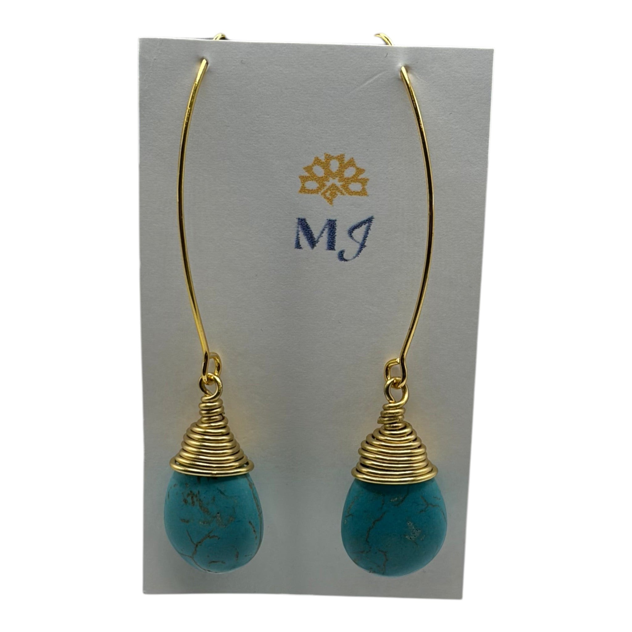 CURATED by Kira MINU Jewels turquoise teardrop dangle earrings with gold tone wire wrap detail on display card