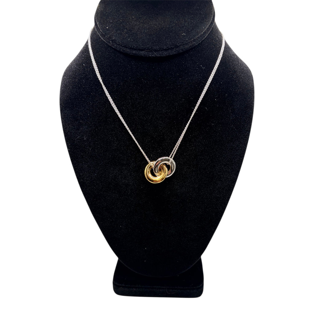 CURATED by Kira kate spade new york two-tone interlock ring pendant necklace on a black display bust