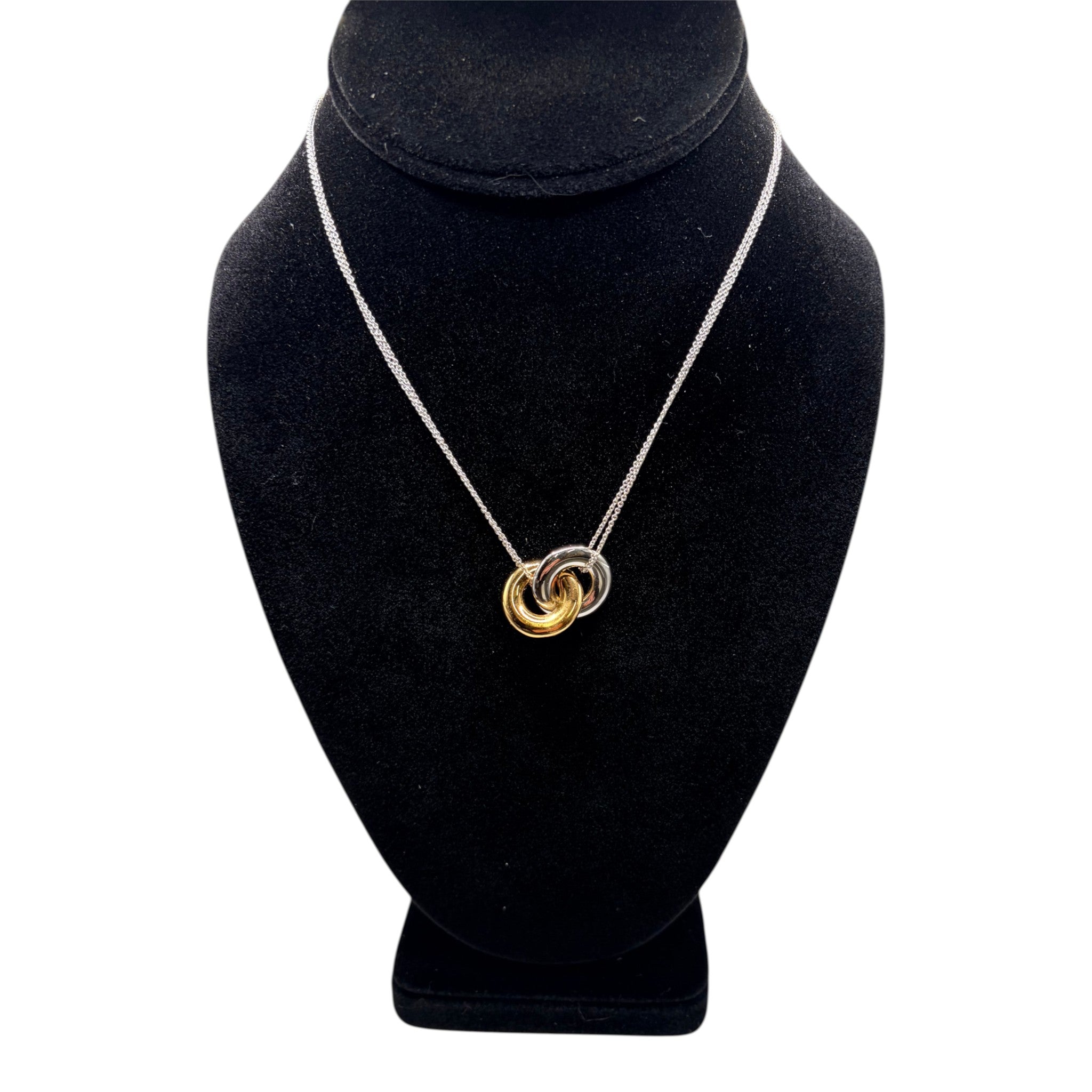 CURATED by Kira kate spade new york two-tone interlock ring pendant necklace on a black display bust
