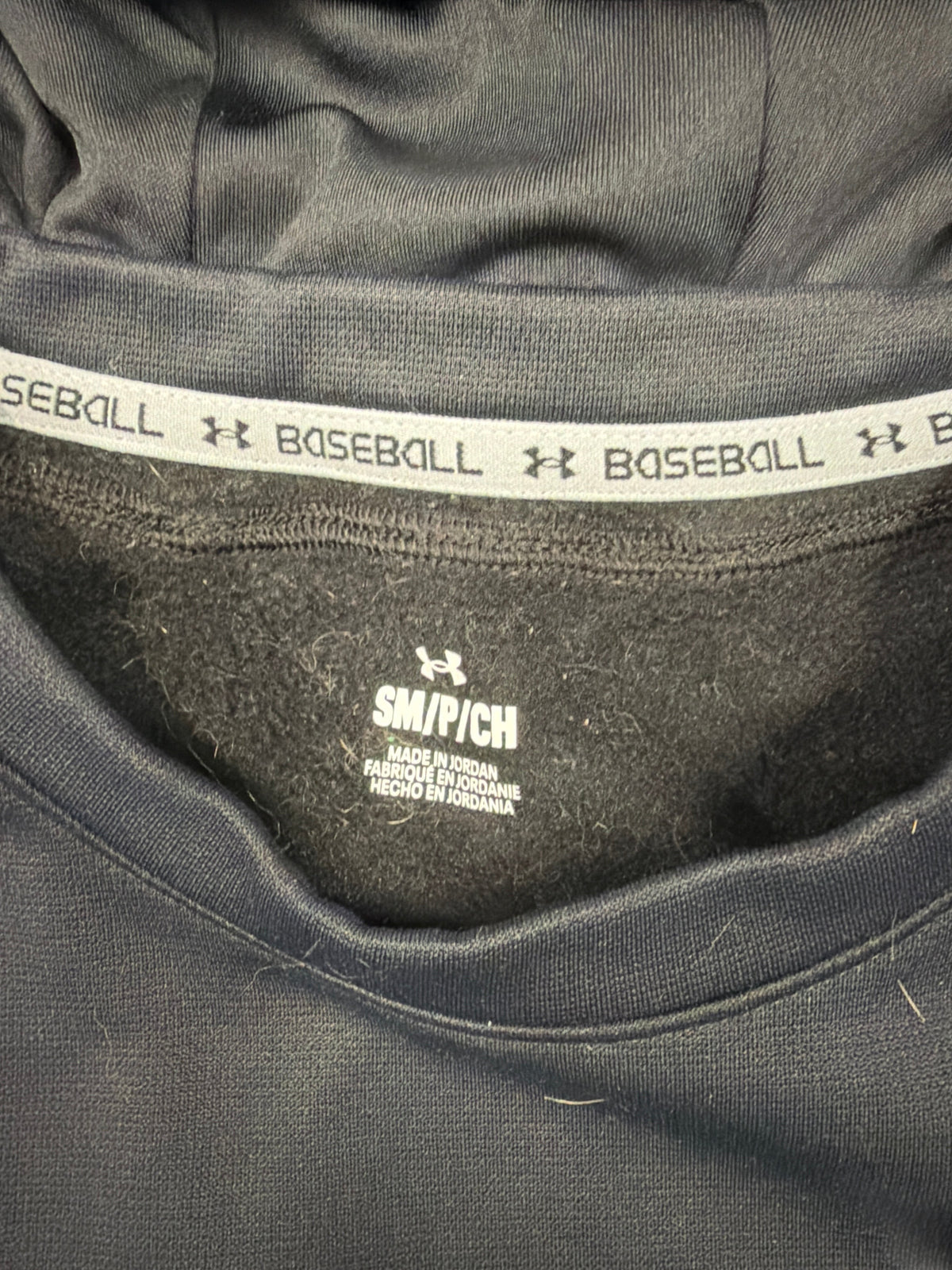 CURATED by Kira Under Armour men's black baseball hoodie interior neck tape detail with branded trim