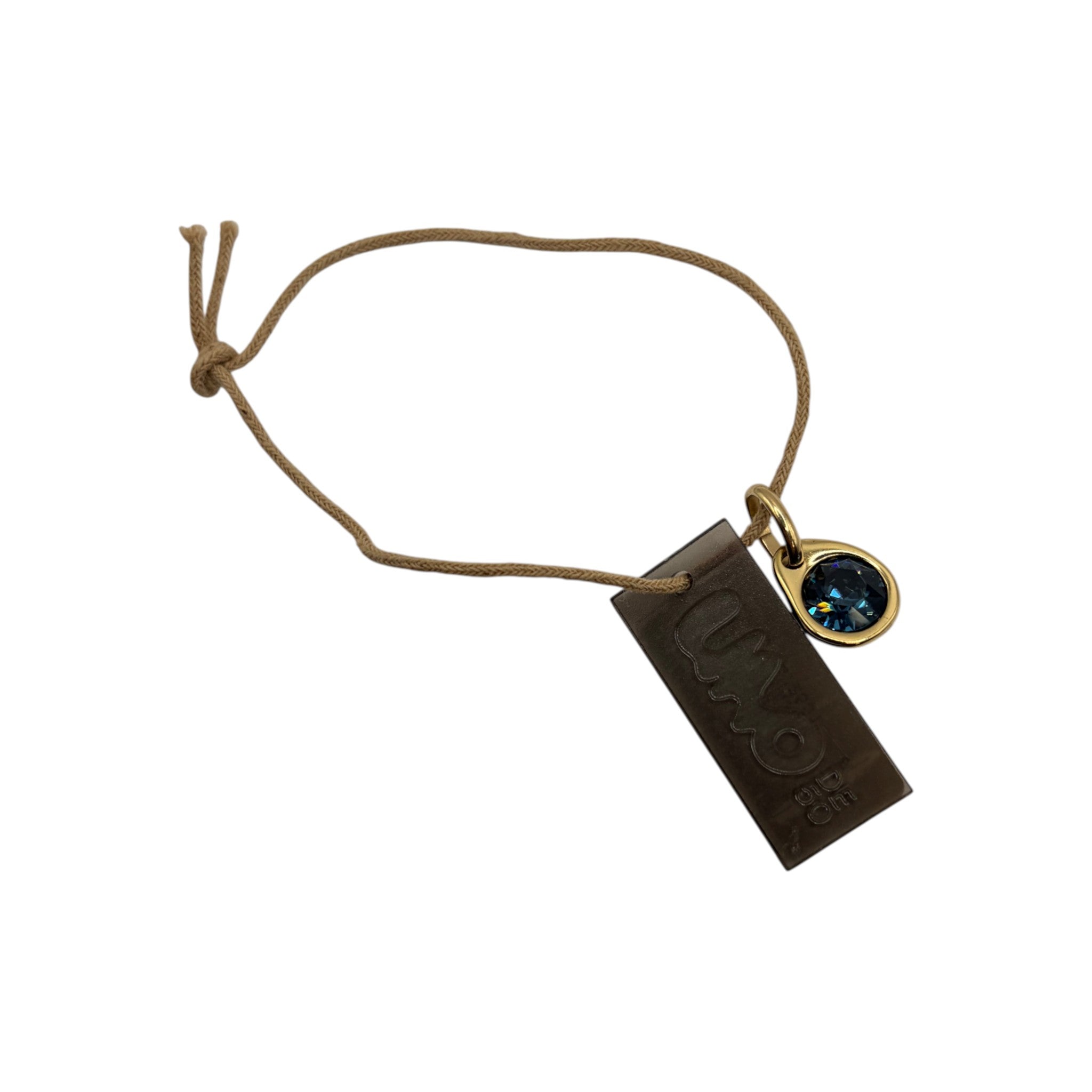 CURATED by Kira Uno de 50 gold tone ball and green crystal drop charm set on a brown cord with branded tag