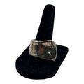 CURATED by Kira Uno de 50 style chunky oxidized silver ring with an organic freeform shape on a black display stand.