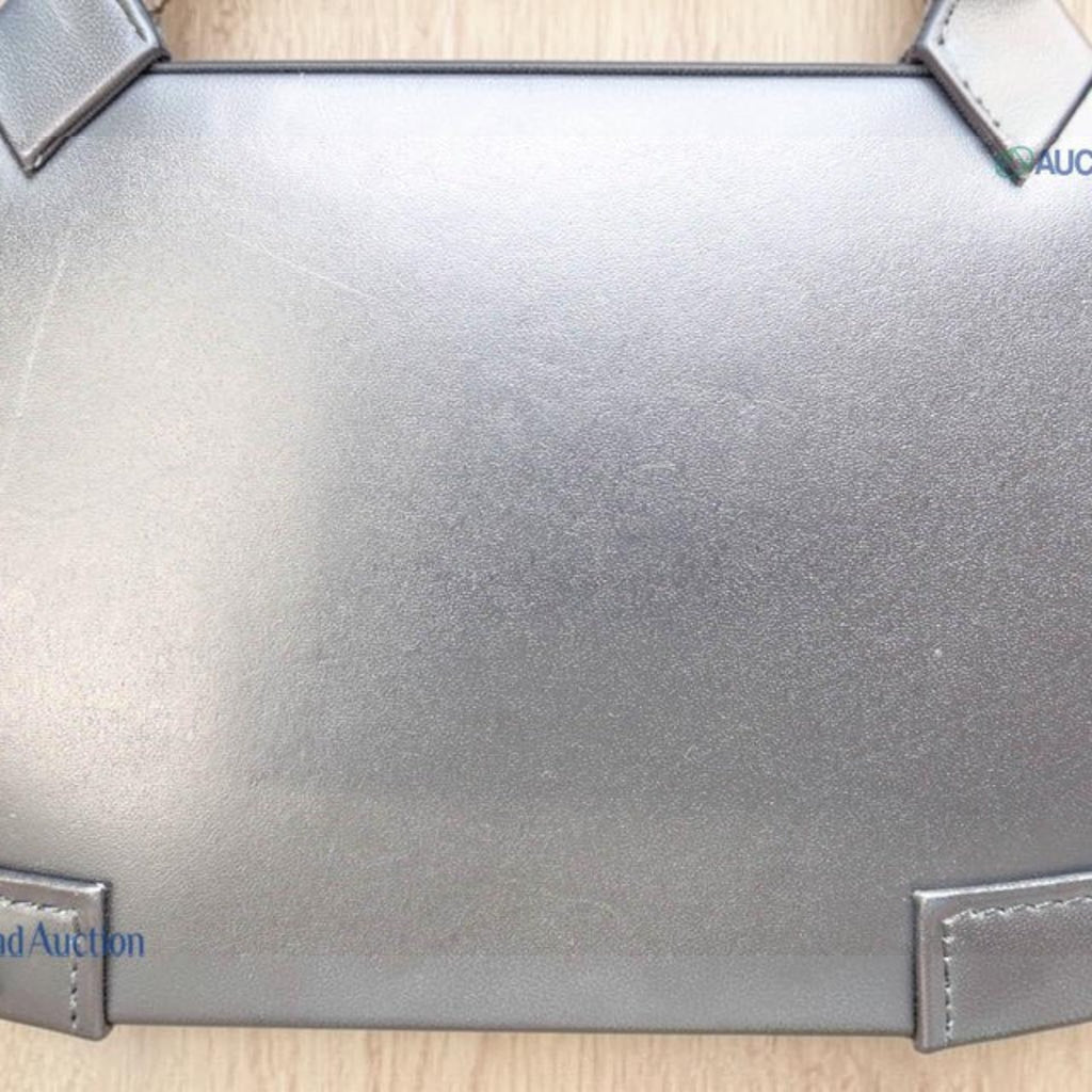 CURATED by Kira Vivienne Westwood black enamel handbag with a smooth structured finish and stitched corner details
