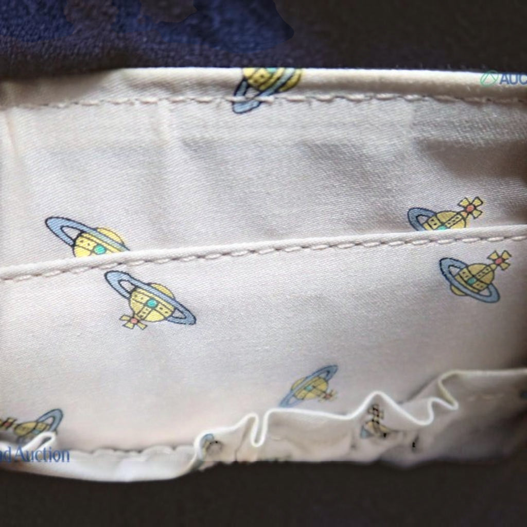 CURATED by Kira Vivienne Westwood handbag interior featuring beige fabric with signature Saturn orb logo print