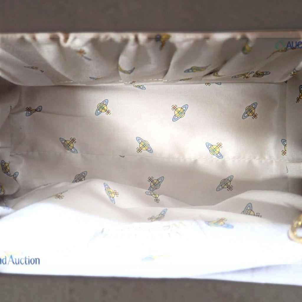 CURATED by Kira Vivienne Westwood enamel handbag interior featuring cream fabric lining with iconic orb logo pattern