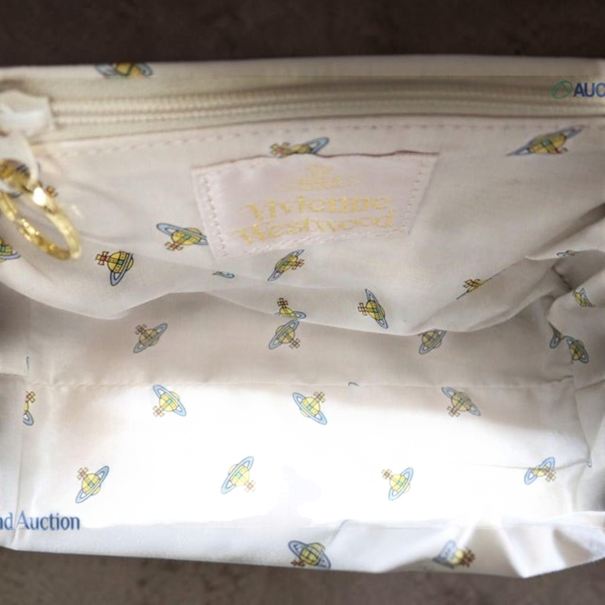 CURATED by Kira Vivienne Westwood black enamel handbag interior featuring branded fabric lining with orb logo pattern