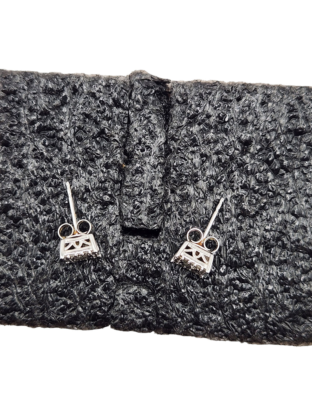 CURATED by Kira 14K white gold halo diamond stud earrings with push-back closures on black textured display
