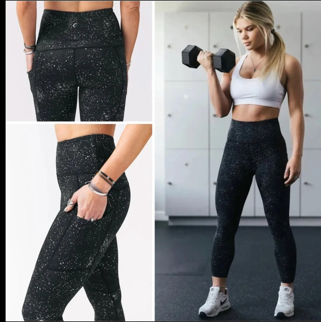 CURATED by Kira Zyia Active black high-rise leggings with silver reflective splatter, side pockets, and compression fit.