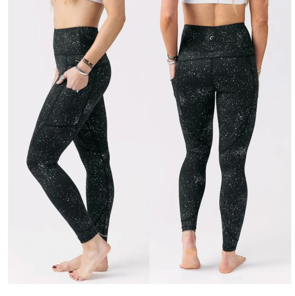 CURATED by Kira Zyia Active black high-rise leggings with reflective silver splatter pattern and side pockets.