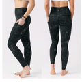CURATED by Kira Zyia Active black high-rise leggings with reflective silver splatter pattern and side pockets.